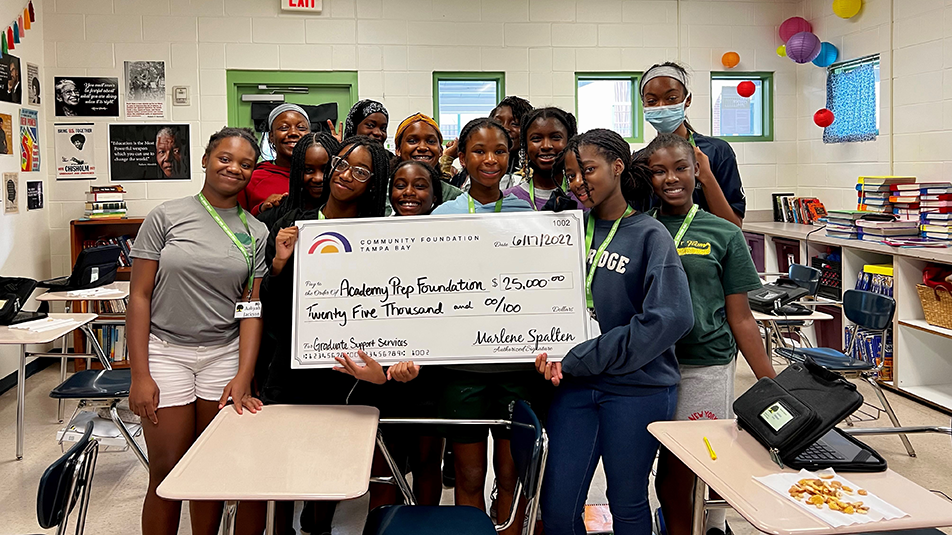 Academy Prep, students holding a big check